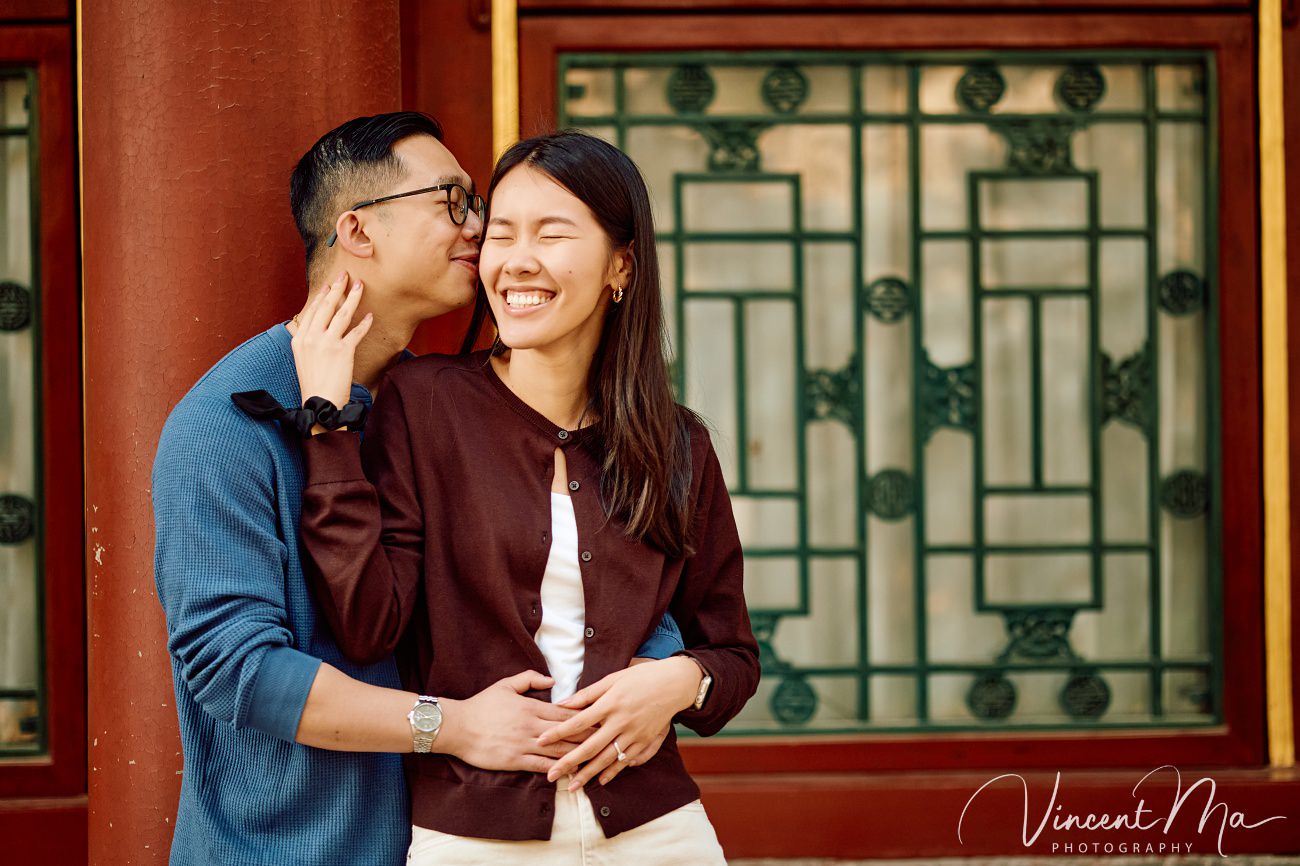 Close-up of an engagement ring held against a backdrop of spring magnolias and cherry blossoms at the Summer Palace, Beijing. Symbol of love in the heart of China.
