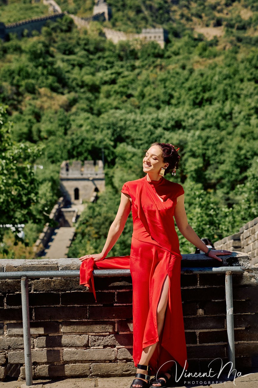 Candid fashion photography of a woman walking through an empty watchtower at Mutianyu. Documentary-style solo travel narrative in Beijing.