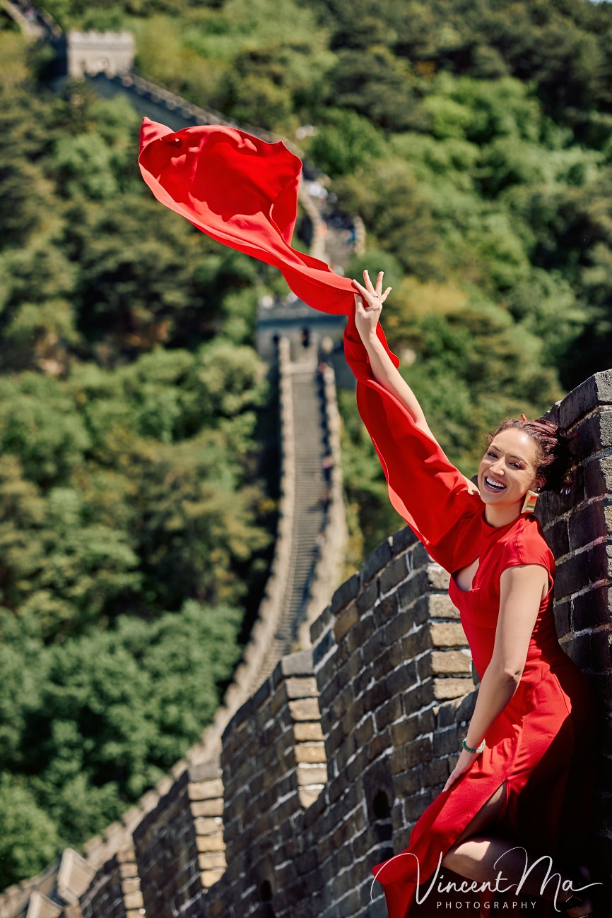 Candid fashion photography of a woman walking through an empty watchtower at Mutianyu. Documentary-style solo travel narrative in Beijing.